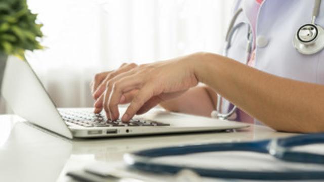 GP updating medical record after a patient consultation